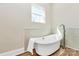 Bright bathroom features a freestanding tub with tile surround and wood-look flooring at 609 Rosemore Pl, Rock Hill, SC 29732