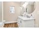 Double vanity bathroom with marble countertop, dual sinks, and new wood-look vinyl flooring at 609 Rosemore Pl, Rock Hill, SC 29732