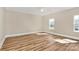 Spacious bedroom has natural light, ceiling fan, and wood-look flooring at 609 Rosemore Pl, Rock Hill, SC 29732