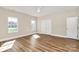 Bright bedroom features two windows, closet, and wood-look flooring at 609 Rosemore Pl, Rock Hill, SC 29732