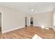 Empty bedroom with hardwood floors, a ceiling fan, and multiple doorways at 609 Rosemore Pl, Rock Hill, SC 29732