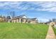 Exterior view of a brick home with an expansive lawn, showcasing a well-maintained landscape at 609 Rosemore Pl, Rock Hill, SC 29732