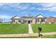 Exterior view of a brick home with manicured lawn and inviting entrance, showcasing curb appeal at 609 Rosemore Pl, Rock Hill, SC 29732