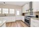 Well-lit kitchen boasting stainless steel appliances, light countertops and tile backsplash at 609 Rosemore Pl, Rock Hill, SC 29732