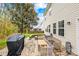 Backyard patio with grill, fire pit, outdoor seating, and green foliage creates inviting outdoor space at 6126 Castlecove Rd, Charlotte, NC 28278