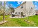 Enjoy outdoor living with a stone patio, lush lawn, and a grill perfect for entertaining at 6126 Castlecove Rd, Charlotte, NC 28278