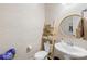 Stylish half bathroom featuring designer wallpaper, a round mirror, and a space-saving shelving unit at 6126 Castlecove Rd, Charlotte, NC 28278