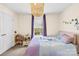 Cozy bedroom with soft lighting, window view, and quaint dollhouse adding character at 6126 Castlecove Rd, Charlotte, NC 28278