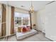 Bright bedroom with large window, chandelier, and plush pillows creating a cozy and inviting atmosphere at 6126 Castlecove Rd, Charlotte, NC 28278
