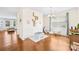 Elegant dining area with hardwood floors, white wainscoting, and a modern chandelier creating a stylish space at 6126 Castlecove Rd, Charlotte, NC 28278