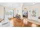 Sunlit foyer features hardwood floors, an adjacent dining area, and a view into a bright, open-concept space at 6126 Castlecove Rd, Charlotte, NC 28278