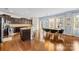 A modern kitchen featuring dark wood cabinetry, granite countertops, and stainless steel appliances at 6126 Castlecove Rd, Charlotte, NC 28278