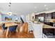 Open concept living area with a kitchen island and dining and living spaces with a fireplace at 6126 Castlecove Rd, Charlotte, NC 28278