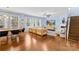 Spacious living room with hardwood floors, large windows, and a cozy fireplace, ideal for entertaining at 6126 Castlecove Rd, Charlotte, NC 28278
