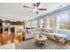 Open-concept living room and kitchen area featuring hardwood floors, large windows, and ample natural light at 6126 Castlecove Rd, Charlotte, NC 28278