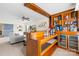 A gorgeous wet bar features beautiful wooden shelves, a sink, and a cooler at 6126 Castlecove Rd, Charlotte, NC 28278