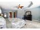 Spacious main bedroom featuring a tray ceiling, ceiling fan, a chest of drawers, and ensuite bathroom at 6423 Red Maple Dr, Charlotte, NC 28277