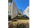 View of the backyard showcasing the proximity to a neighboring house and a glimpse of a wooden fence at 719 Mountain Quail Dr # 34, Charlotte, NC 28216