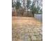 Large, unfenced backyard area, paved patio, and mature trees at 719 Mountain Quail Dr # 34, Charlotte, NC 28216
