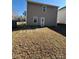 View of the backyard showcasing a simple landscape with potential for outdoor enjoyment and relaxation at 719 Mountain Quail Dr # 34, Charlotte, NC 28216