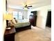 Bright bedroom with carpet flooring, a ceiling fan, and a large window at 719 Mountain Quail Dr # 34, Charlotte, NC 28216