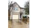 Two-story home with neutral siding, light shutters, attached garage, and landscaping at 719 Mountain Quail Dr # 34, Charlotte, NC 28216