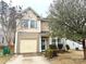 Two-story home featuring a single-car garage, manicured landscaping, and charming architectural details at 719 Mountain Quail Dr # 34, Charlotte, NC 28216