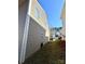 View of the side yard showing the house's exterior siding and proximity to the neighboring property at 719 Mountain Quail Dr # 34, Charlotte, NC 28216