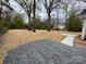 View of a spacious backyard with mature trees and a newly installed walkway, ready for landscaping at 723 S Confederate Ave, Rock Hill, SC 29730