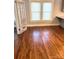 Open living room area featuring gleaming hardwood floors and glass french doors at 723 S Confederate Ave, Rock Hill, SC 29730