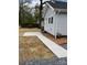 View of backyard with concrete path, mulch bed, and neutral siding at 723 S Confederate Ave, Rock Hill, SC 29730