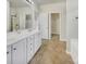 Bright bathroom featuring a double vanity, a separate shower, and a walk-in closet for ample storage at 7400 Gilead Rd, Huntersville, NC 28078