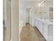 Bright bathroom with double vanity, tub, and shower, featuring neutral tile flooring and modern fixtures at 7400 Gilead Rd, Huntersville, NC 28078