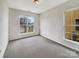 This bedroom is spacious, features new carpet, and lets in a lot of natural light at 7400 Gilead Rd, Huntersville, NC 28078