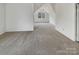 Large bedroom with carpet flooring, an attic ceiling, and a large window at 7400 Gilead Rd, Huntersville, NC 28078