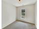 Empty bedroom with neutral walls and carpet with natural light at 7400 Gilead Rd, Huntersville, NC 28078