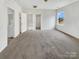 This spacious bedroom features carpet flooring, a large window, and a walk-in closet at 7400 Gilead Rd, Huntersville, NC 28078