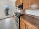 This modern kitchen features stainless steel appliances, wood cabinets, and a flat-top range at 7400 Gilead Rd, Huntersville, NC 28078