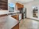 This spacious kitchen features stainless steel appliances, wood cabinets, and lots of natural light at 7400 Gilead Rd, Huntersville, NC 28078