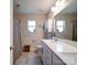 Neutral bathroom featuring a double sink vanity, shower with curtain, and decorative accents at 7504 Canova Ln # 5, Charlotte, NC 28278