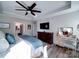 Bright main bedroom with an ensuite bathroom, tray ceiling, tv and hardwood floors at 7504 Canova Ln # 5, Charlotte, NC 28278