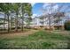 Backyard and exterior of building with balconies and manicured lawn at 8629 Coralbell Ln, Charlotte, NC 28213