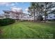Backyard with manicured lawn and a view of the building with balconies at 8629 Coralbell Ln, Charlotte, NC 28213