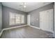 Bright bedroom features neutral walls, light-colored vinyl floors, and a ceiling fan at 8629 Coralbell Ln, Charlotte, NC 28213