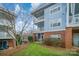 Exterior of building with multiple levels, balconies, a screen porch and a grassy yard at 8629 Coralbell Ln, Charlotte, NC 28213