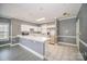 Bright kitchen features white cabinets, stainless steel refrigerator, and bar seating area at 8629 Coralbell Ln, Charlotte, NC 28213