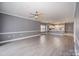 Open living area featuring hardwood floors, neutral paint, and seamless flow to the dining area at 8629 Coralbell Ln, Charlotte, NC 28213