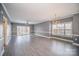 Bright living room with chandelier, ceiling fan, and sliding glass doors overlooking outdoor space at 8629 Coralbell Ln, Charlotte, NC 28213