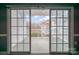 View from a room through sliding glass doors, out to a patio and backyard at 8629 Coralbell Ln, Charlotte, NC 28213