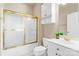 A bathroom with a tub, toilet, and vanity, enhanced by stylish gold fixtures at 8923 Meadow Vista Rd, Charlotte, NC 28213